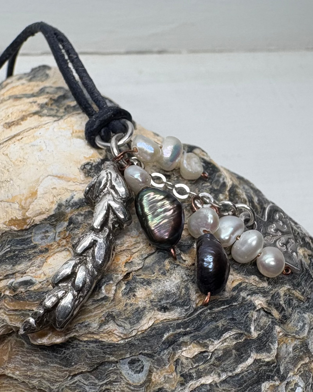 Silver lavender flower charm with freeform natural pearls on a shell background