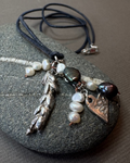 Silver lavender and heart with pearls charm nexklace on black leather cord on a pebble