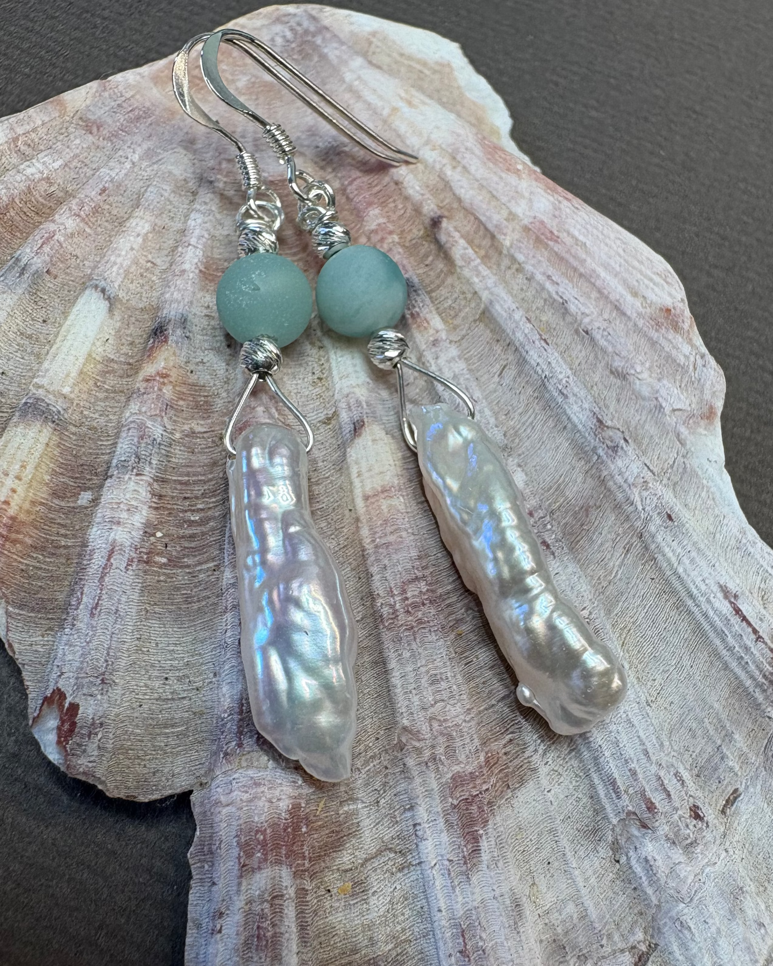 Natural pearl and silver earrings with green agate beads  on a shell