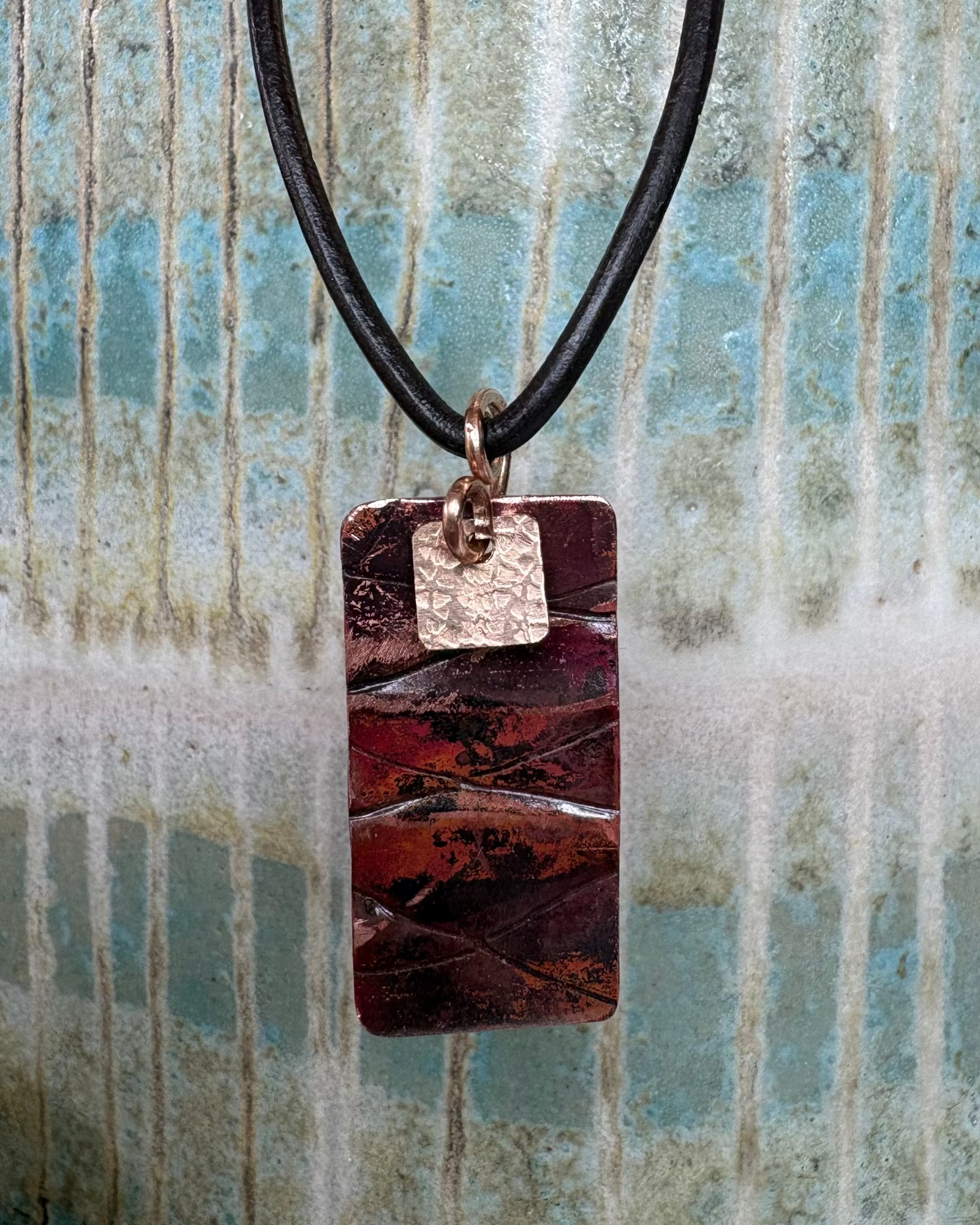 Rectangular oxidised and textured necklace with bronze charm with leather cord