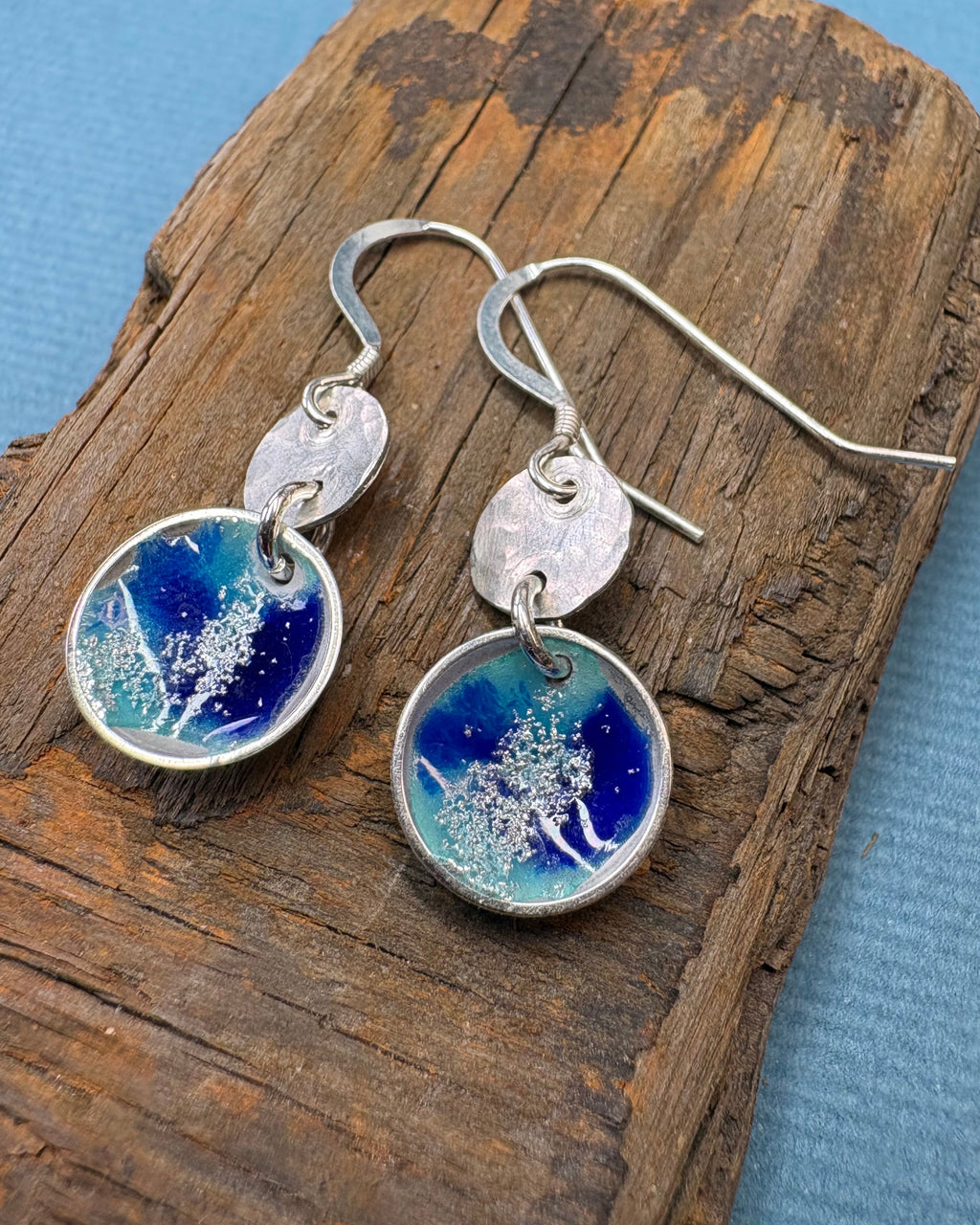 round silver concave enamel disc earrings with blue, aqua and silver to look like pools, with second hammered silver circle disk above, hung on silver ear wires