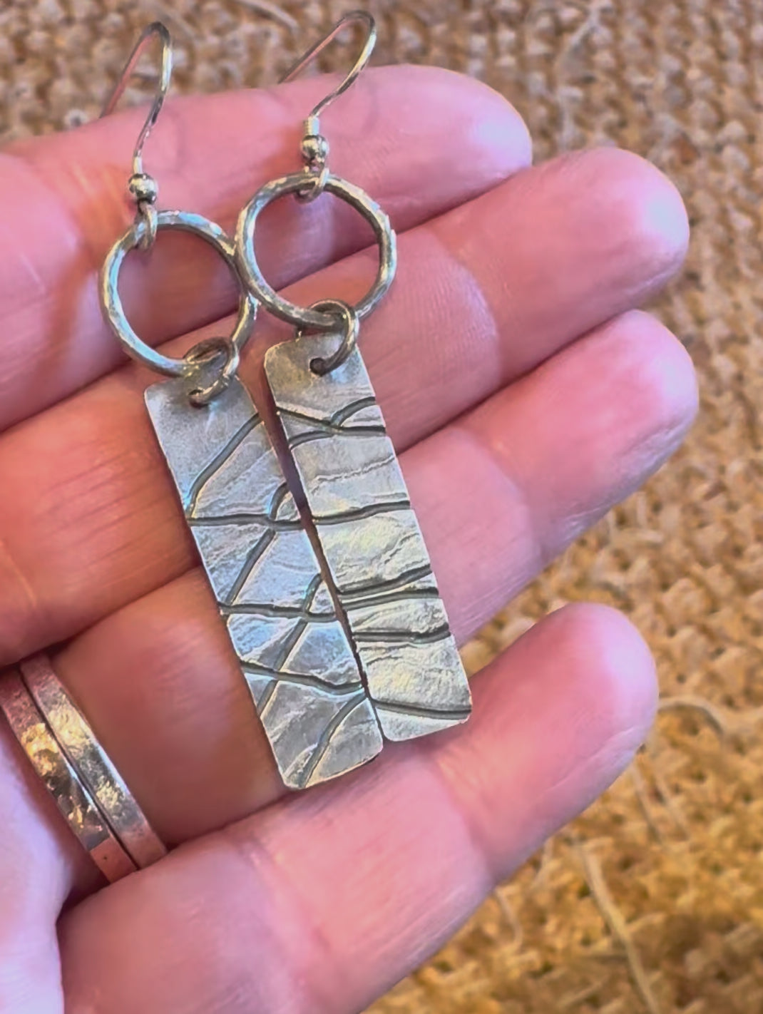 silver hoop and texture earrings showing size and colour