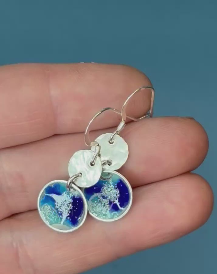 round silver concave enamel disc earrings with blue, aqua and silver to look like pools, with second hammered silver circle disk above, hung on silver ear wires